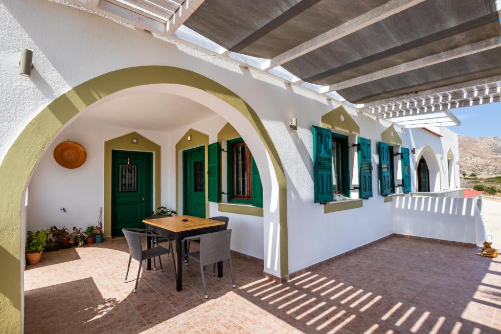 a patio with a table and chairs in a house at Oceanviewvilla in Karpathos