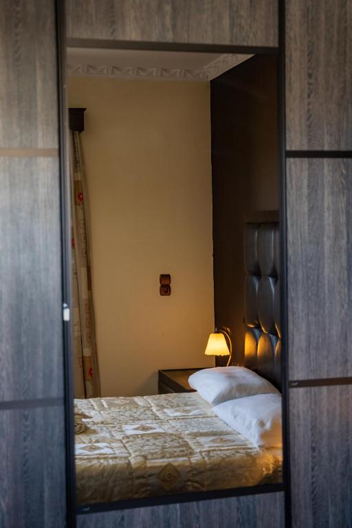 a reflection of a bedroom with a bed in a mirror at Oceanviewvilla in Karpathos