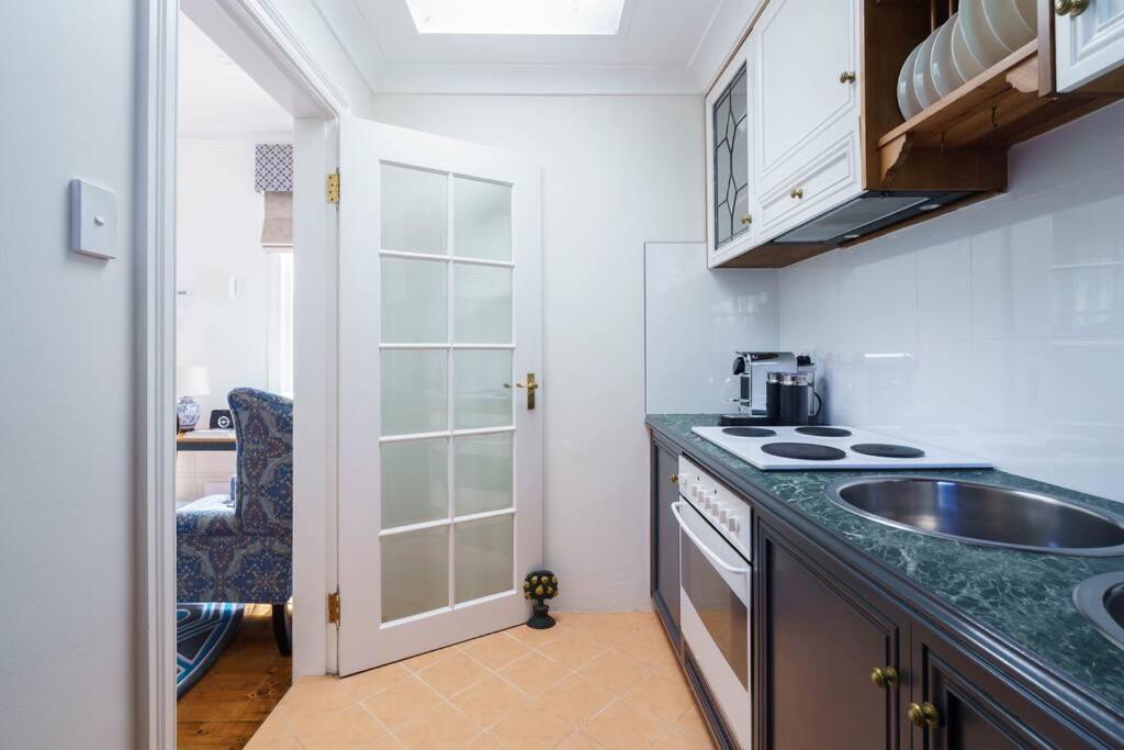 a kitchen with a sink and a counter top at Bryn-y-Mor Cottage Romantic Fireplace Couples in Leura