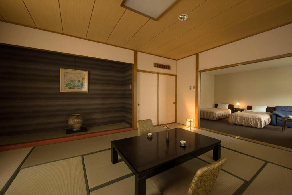 Postel nebo postele na pokoji v ubytování Takamiya Hotel Lucent