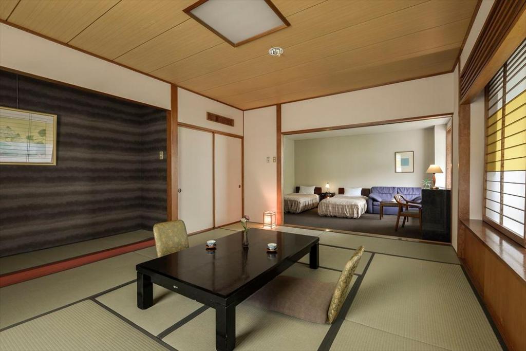 Postel nebo postele na pokoji v ubytování Takamiya Hotel Lucent