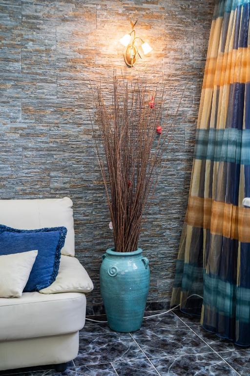 a blue vase sitting next to a couch in a room at Oceanviewvilla in Karpathos
