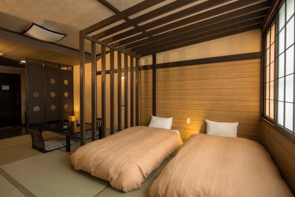 Postel nebo postele na pokoji v ubytování Takamiya Hotel Lucent