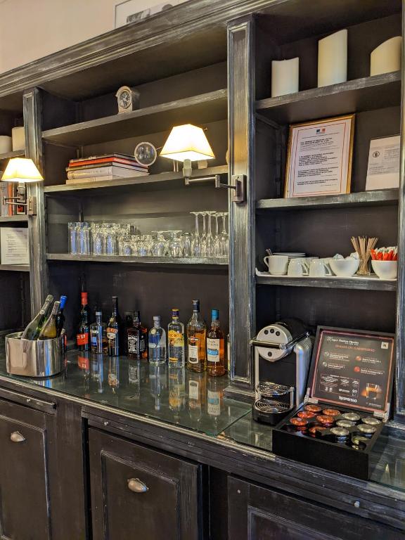 a bar with bottles of alcohol on a counter at Magda Champs Elysées in Paris