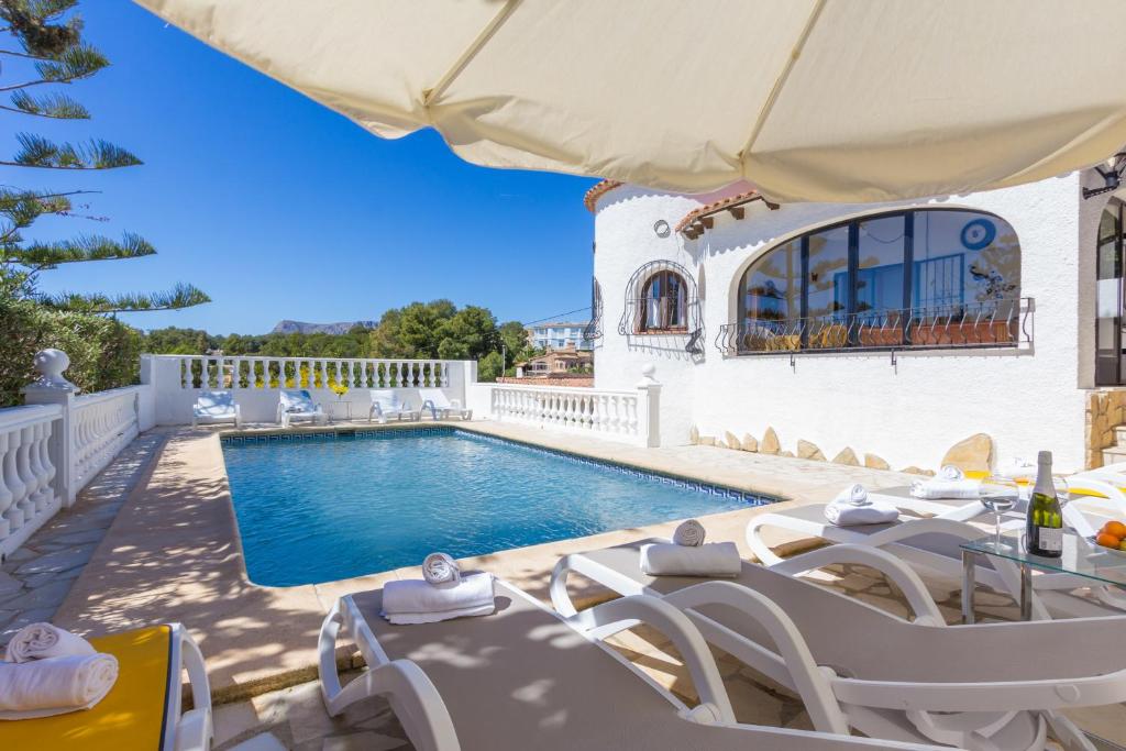 a villa with a swimming pool and patio furniture at Villa Kelly 6 by Abahana Villas in Fanadix