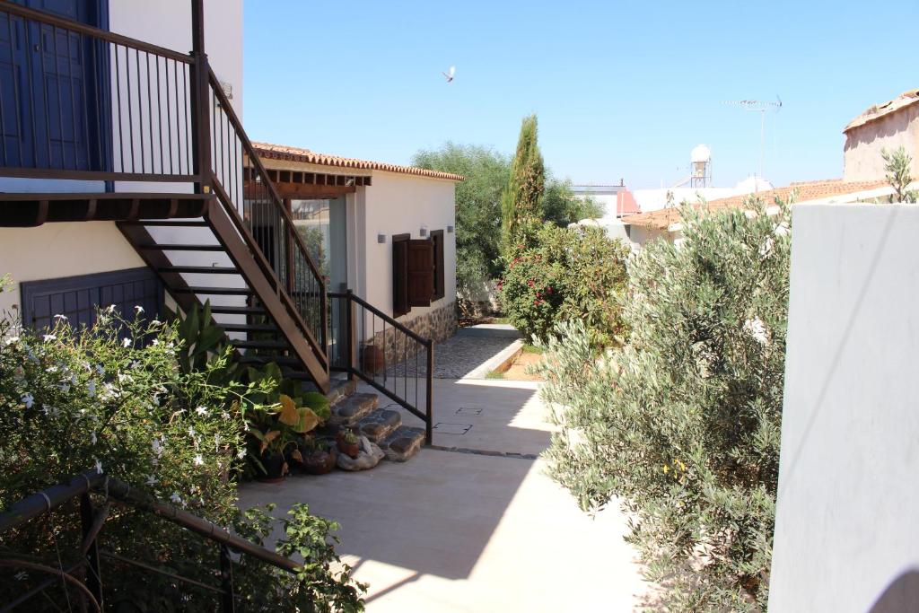 a stairway leading up to a house with a staircase at The Family Nest - Traditional Serenity in Orounda