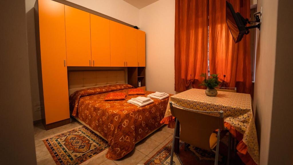 a bedroom with a bed and a table in it at Sole Luna B&B in Pescara