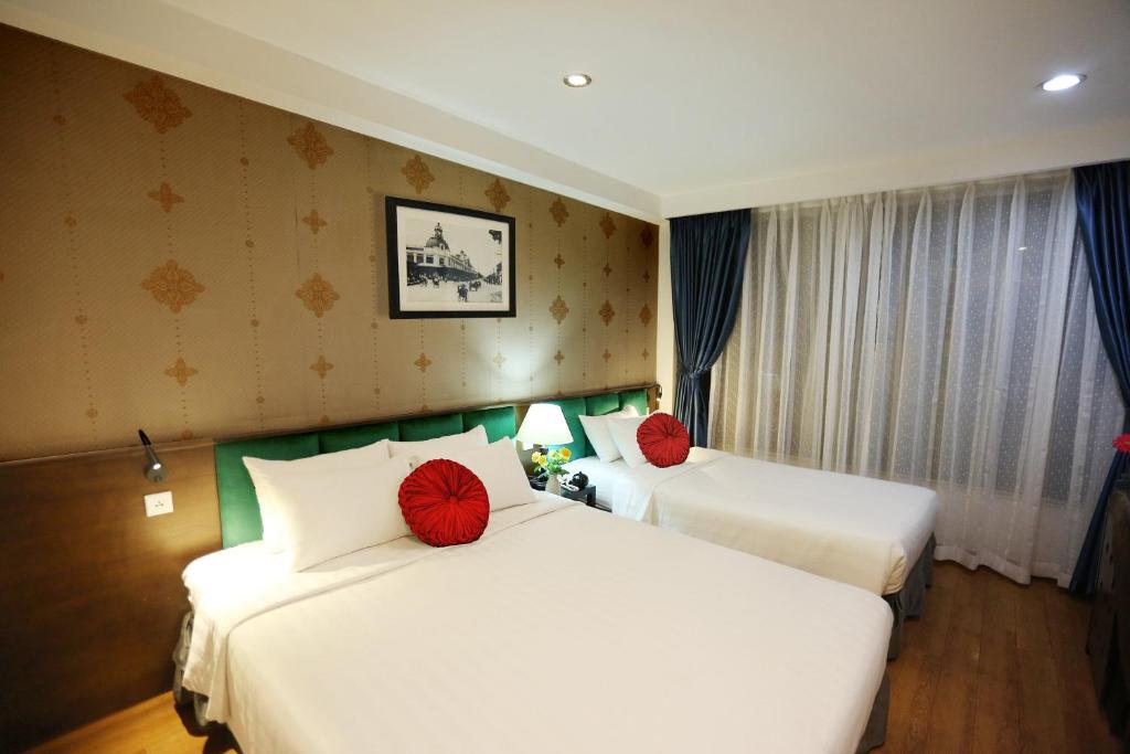 Postel nebo postele na pokoji v ubytování Aviary Hanoi Hotel & Travel