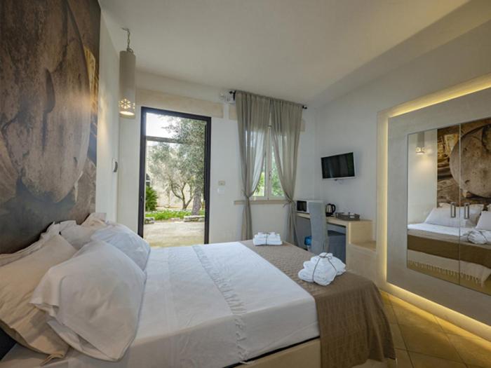 A bed or beds in a room at Tenuta Sidore