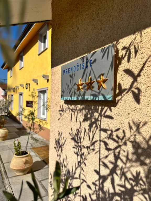 a sign on the side of a building at Hotel Grahor Depandance in Sežana