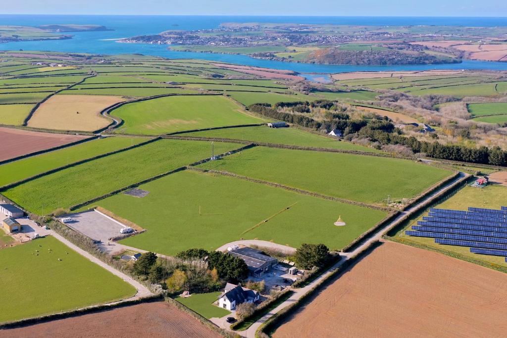 an aerial view of a field with solar panels at Hawk's Nest in Wadebridge