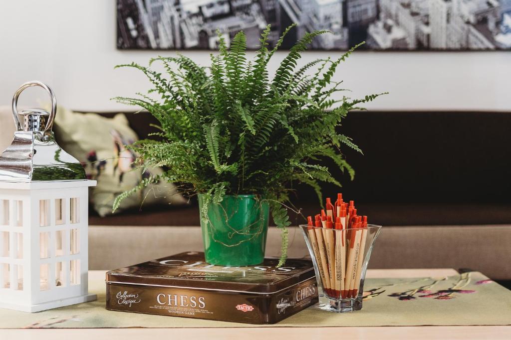 a table with a plant in a vase on a table at Academic Hostel in Tallinn