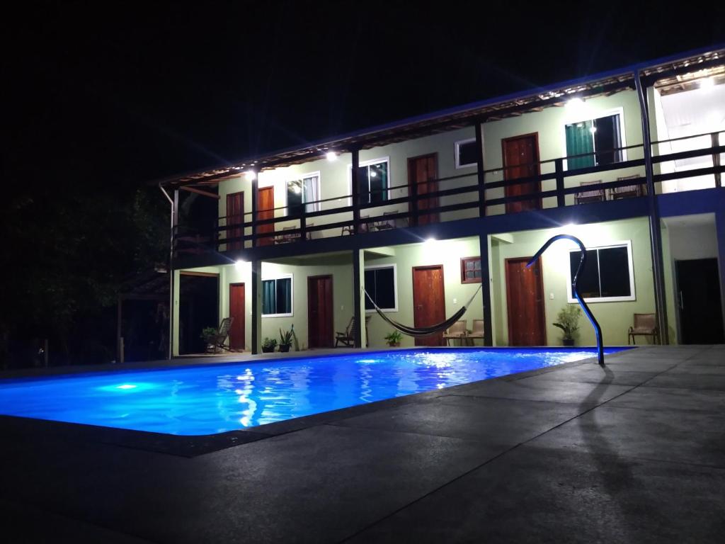 a house with a swimming pool at night at Estadia cipó in Serra do Cipo