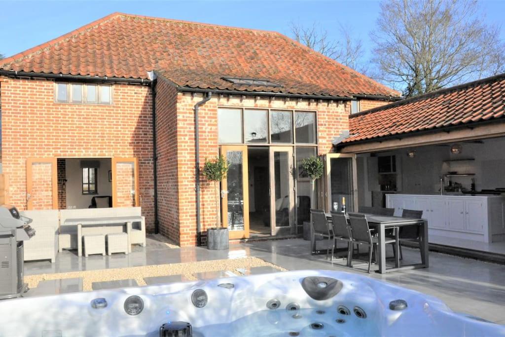 a hot tub in the backyard of a house at The Granary, Norfolk in Norwich