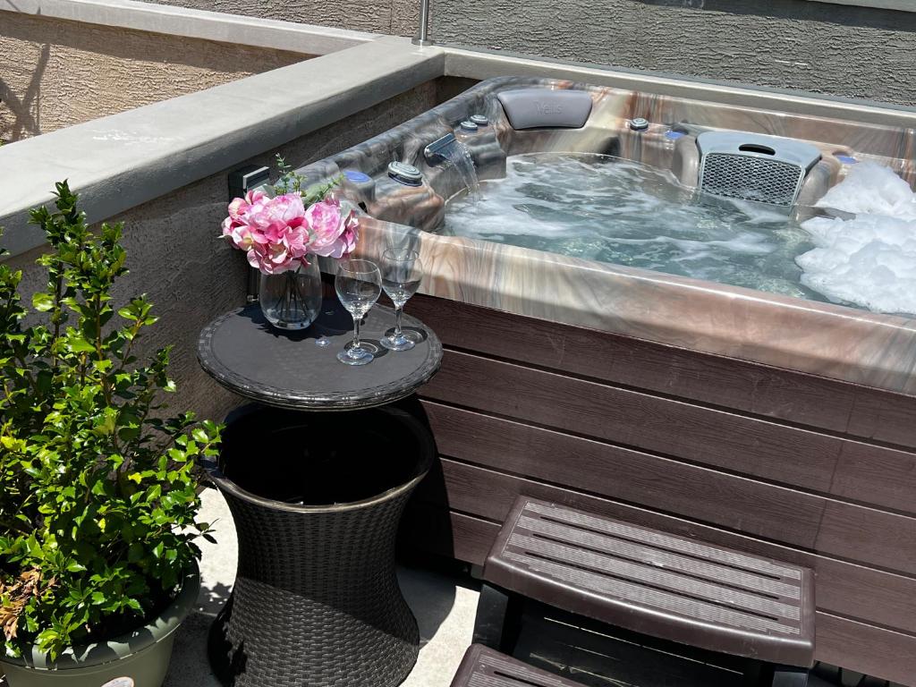 a hot tub with a table and flowers in it at Center City Roofdeck Hot Tub w Garage in Philadelphia