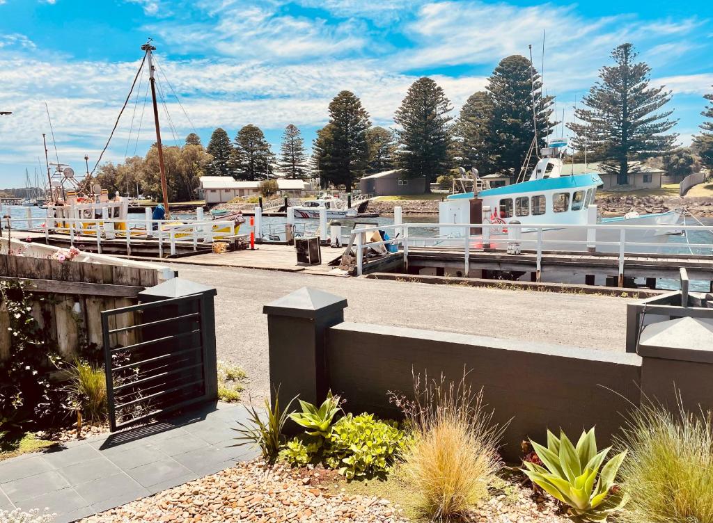 a marina with a boat docked at a dock at Edge17 Port Fairy Wharf in Port Fairy