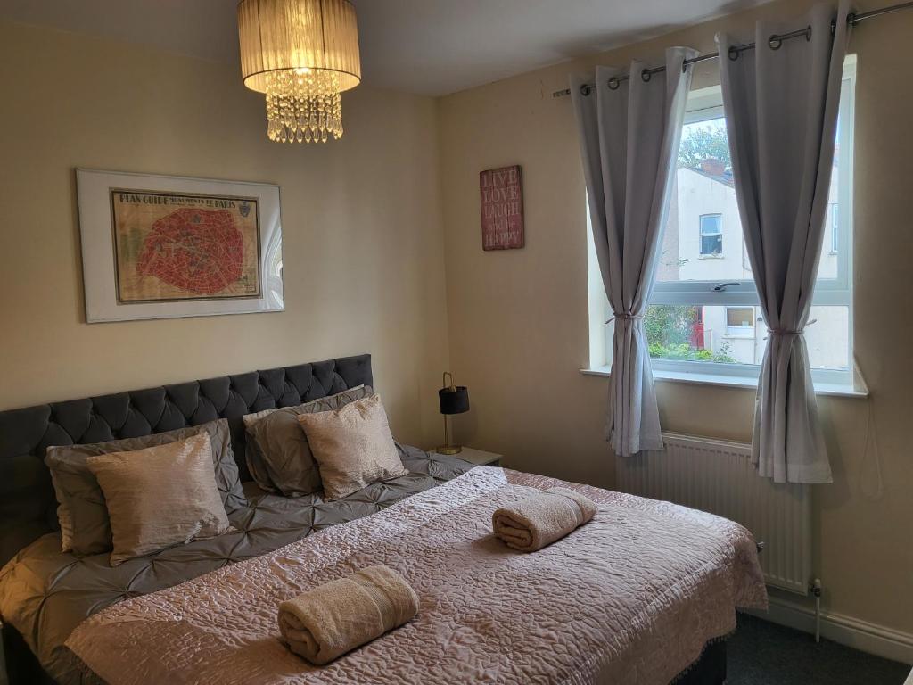 a bedroom with a bed with two pillows on it at & Cosy Apartment in the heart of Stokes Croft in Bristol