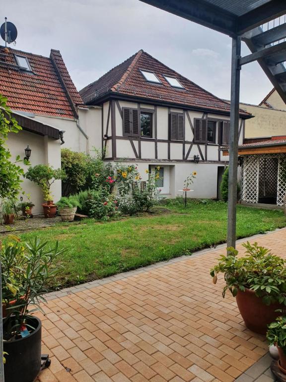 a house with a brick walkway in front of a yard at Auszeit im Rheingau in Eltville