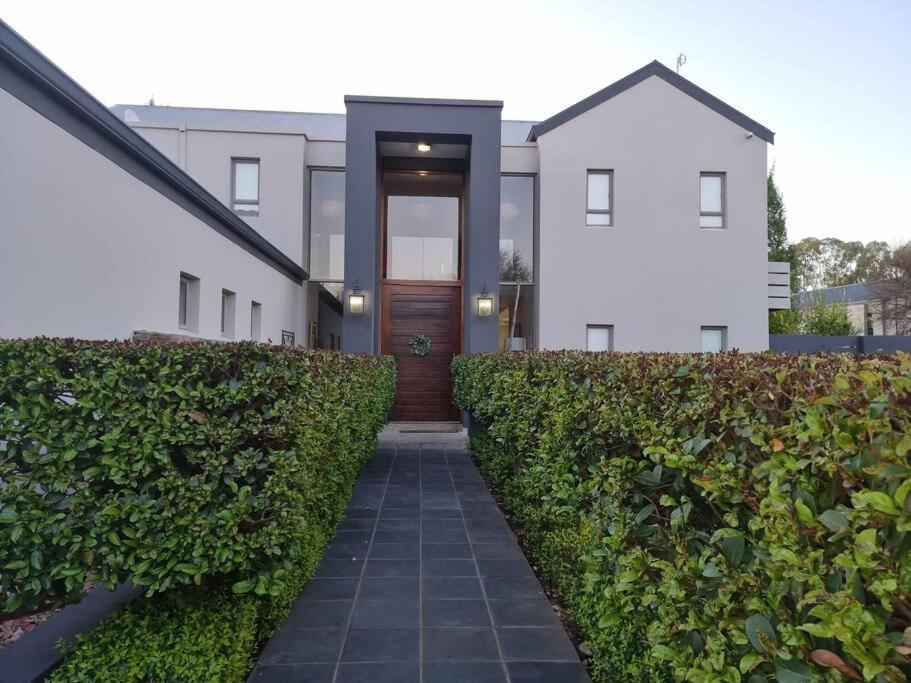 a walkway leading to the front door of a house at Riverfront Golf Estate House in Parys