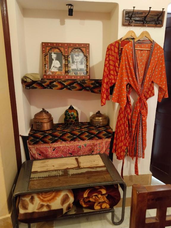 a room with a bed with a table and some pots at Killa Bhawan Lodge in Jaisalmer