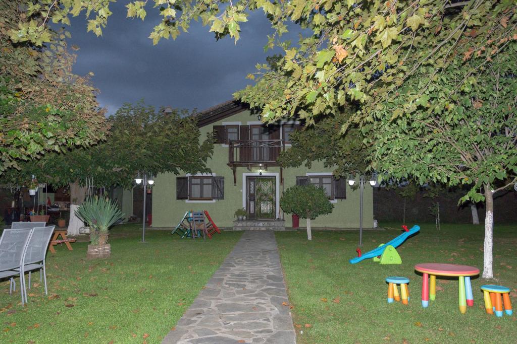 a house with a playground in front of it at Arxontiko Palamas in Palamás