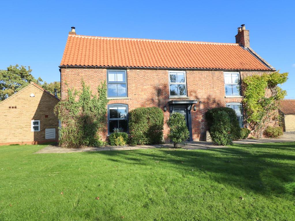 a large brick house with an orange roof at Hall Farm in Market Rasen