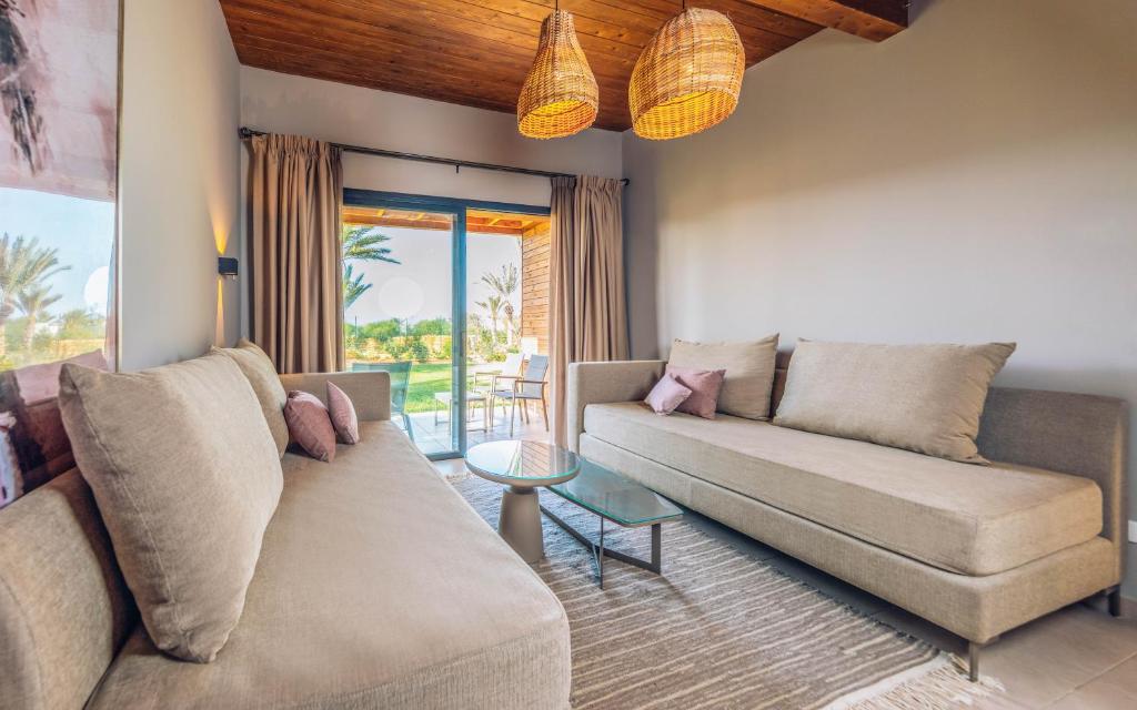 a living room with a couch and a table at Iberostar Waves Mehari Djerba in Taguermess
