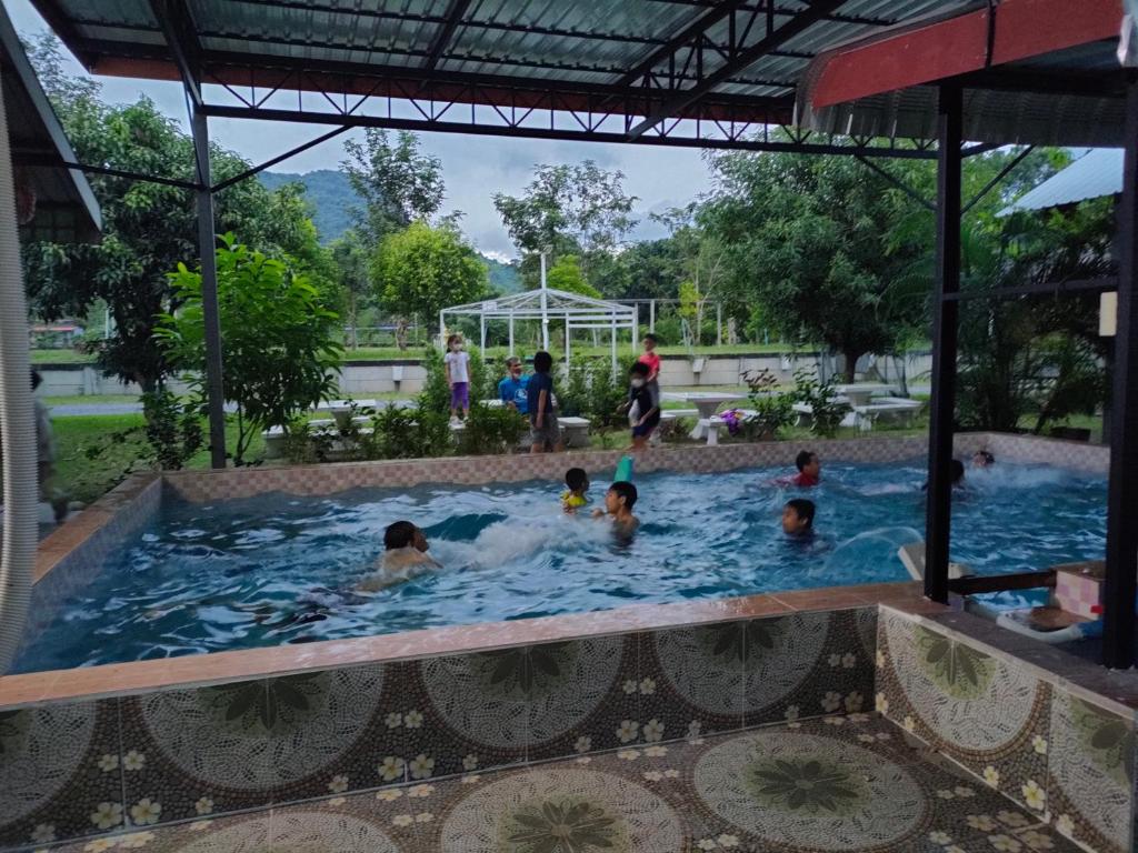 a group of people in a swimming pool at Armthong Resort in Nakhon Nayok