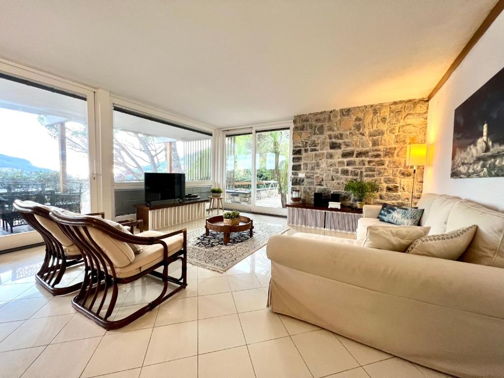 a living room with a couch and a stone wall at VILLA BLUE PANORAMIC PORTOVENERE in Portovenere
