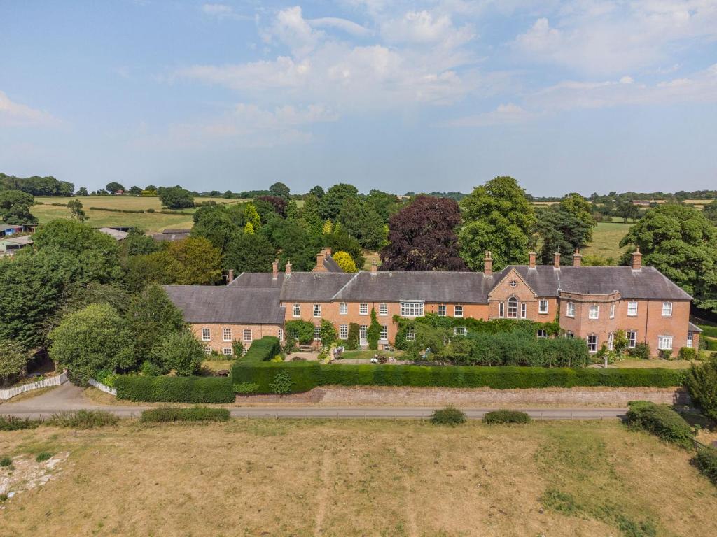 an aerial view of a large brick house at Lady Pond Retreat in Ashbourne