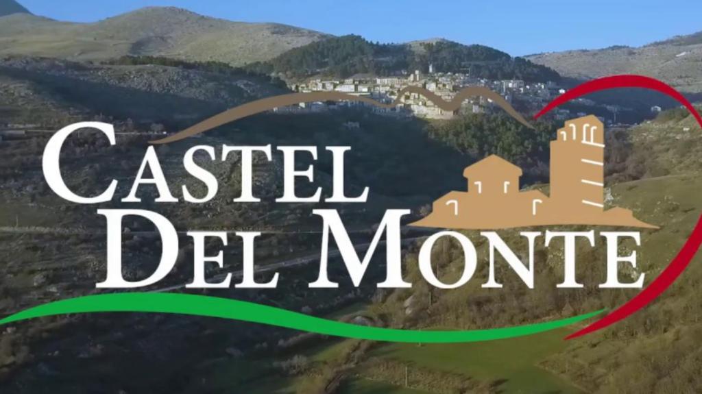 a picture of a castle on a hill with the words castled del monte at Appartamento nel cuore di Campo Imperatore in Castel del Monte