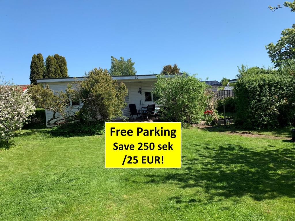 a sign in a yard that reads free parking save turn at Private house Parking Garden Sea Nature in Malmö