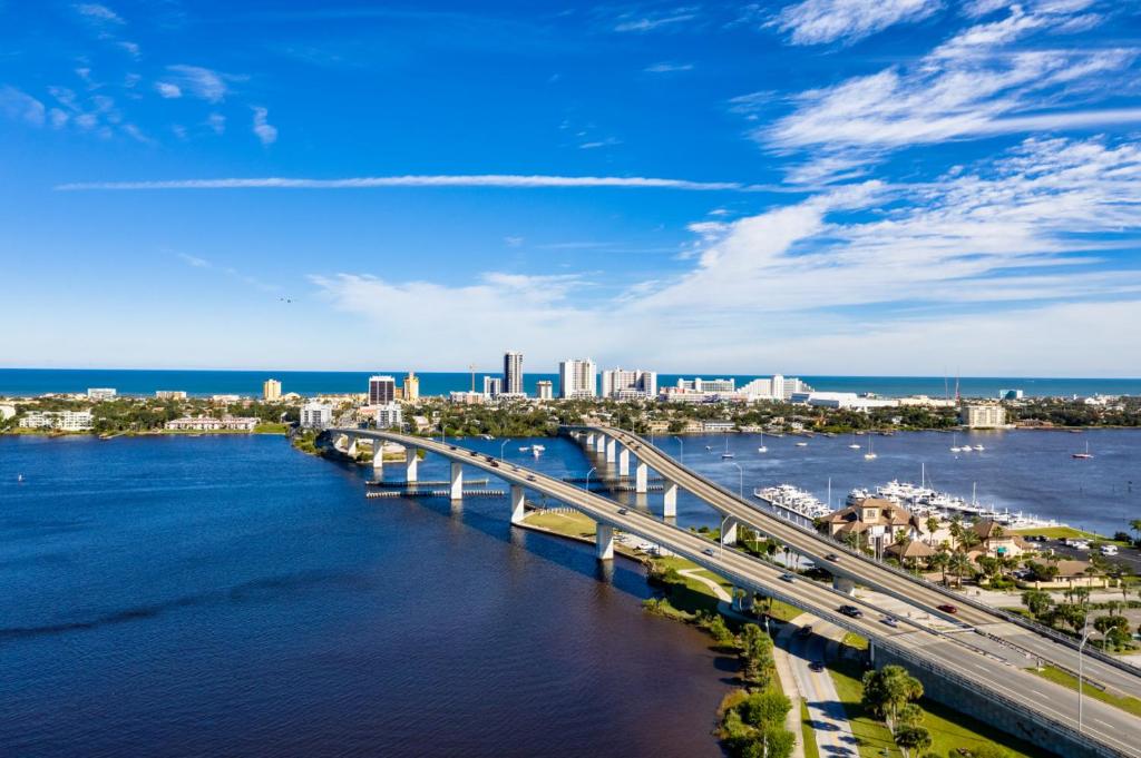 a bridge over the water with a city in the background at Tipsy Turtle Direct Oceanfront in Palm Coast