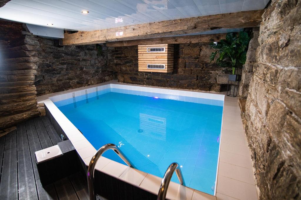 a lap pool in a stone walled house with at Résidence du Pélican in Lannion