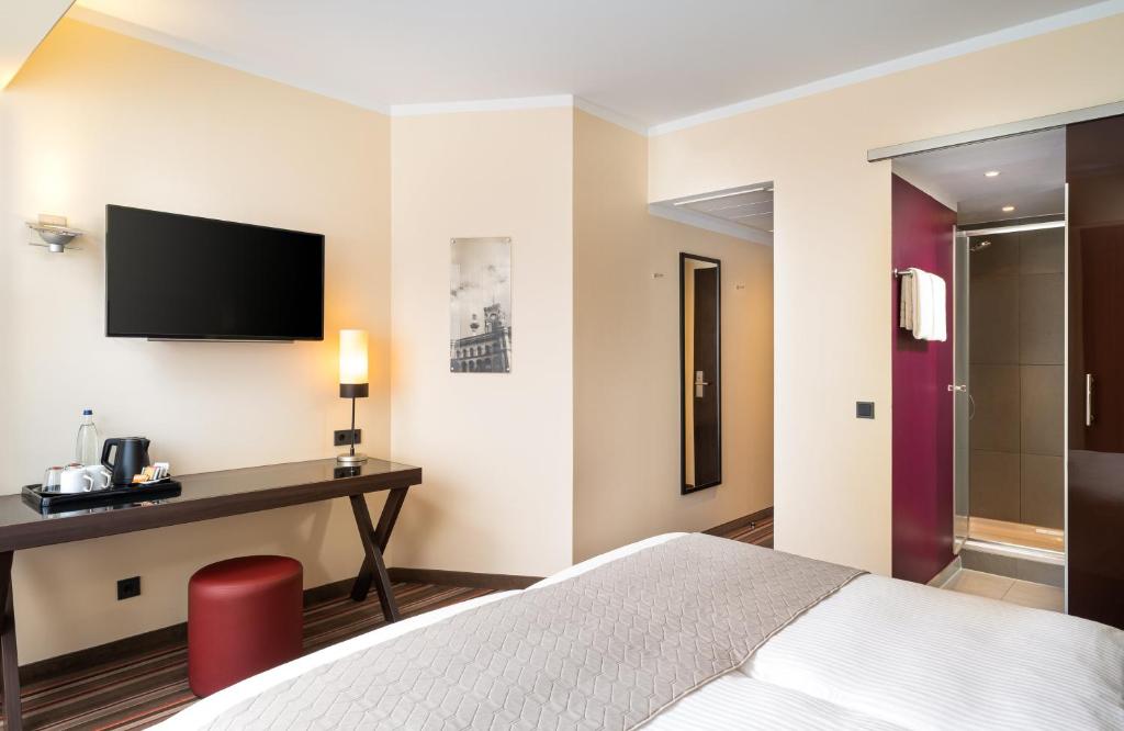 Postel nebo postele na pokoji v ubytování Leonardo Hotel Berlin