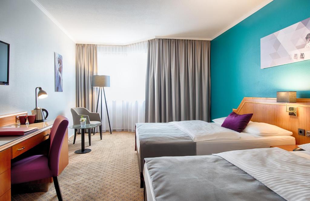 Ένα ή περισσότερα κρεβάτια σε δωμάτιο στο Leonardo Hotel Düsseldorf City Center