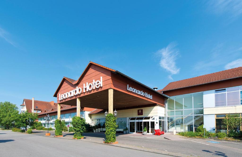 a building with a sign on the front of it at Leonardo Hotel Heidelberg Walldorf in Walldorf