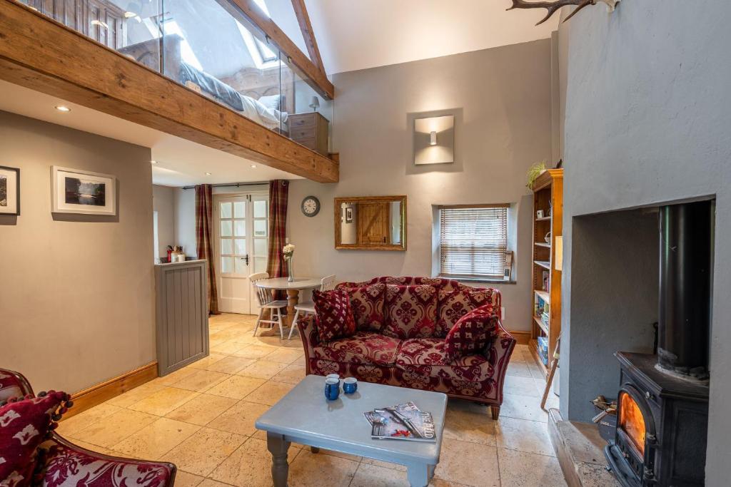 a living room with a couch and a table at Waterside Cottage in Harrogate