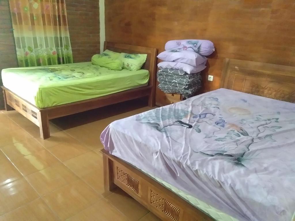 Postel nebo postele na pokoji v ubytování Homestay Arupadhatu Borobudur