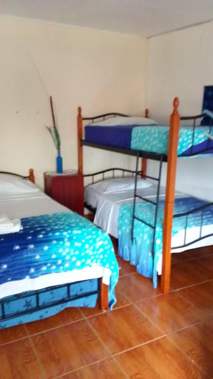 Postel nebo postele na pokoji v ubytování Hostal familiar Villa Nome