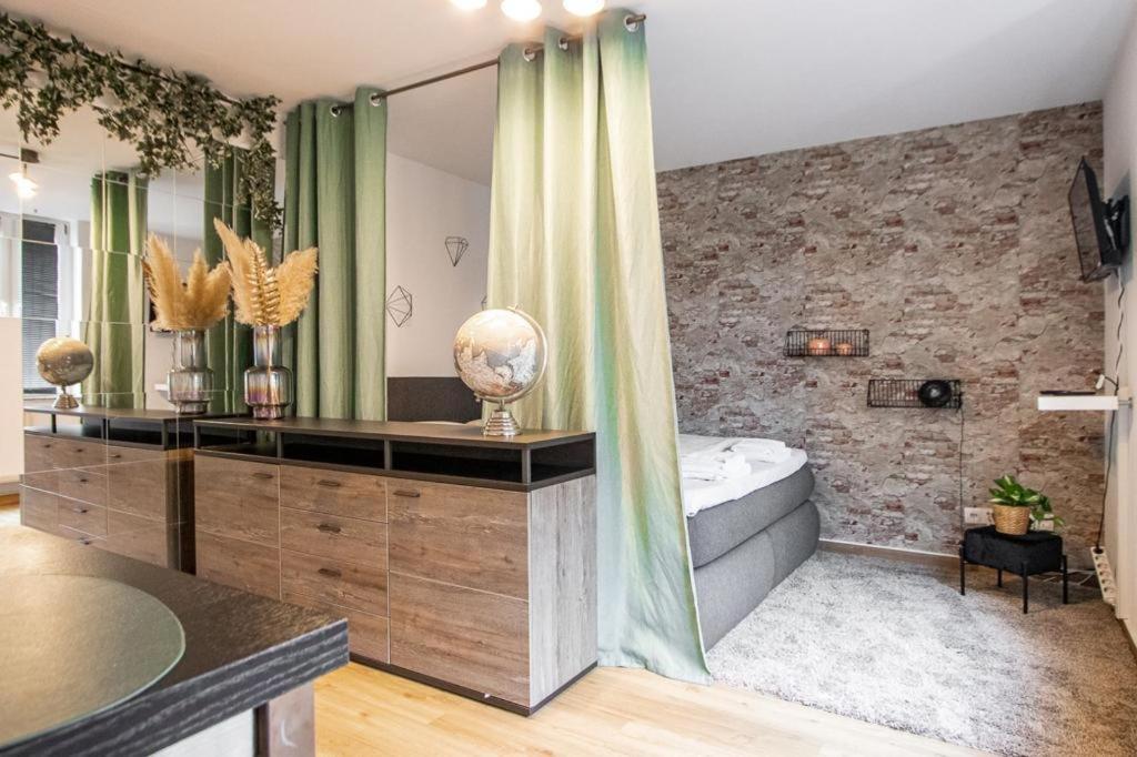 a bathroom with a tub and a stone wall at Ein Stück Heimat mit Netflix in Bielefeld