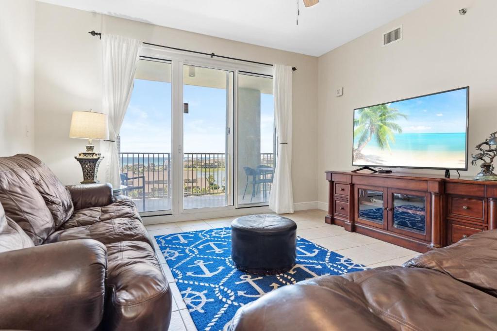 a living room with a couch and a flat screen tv at Ariel Dunes II 602 in Destin