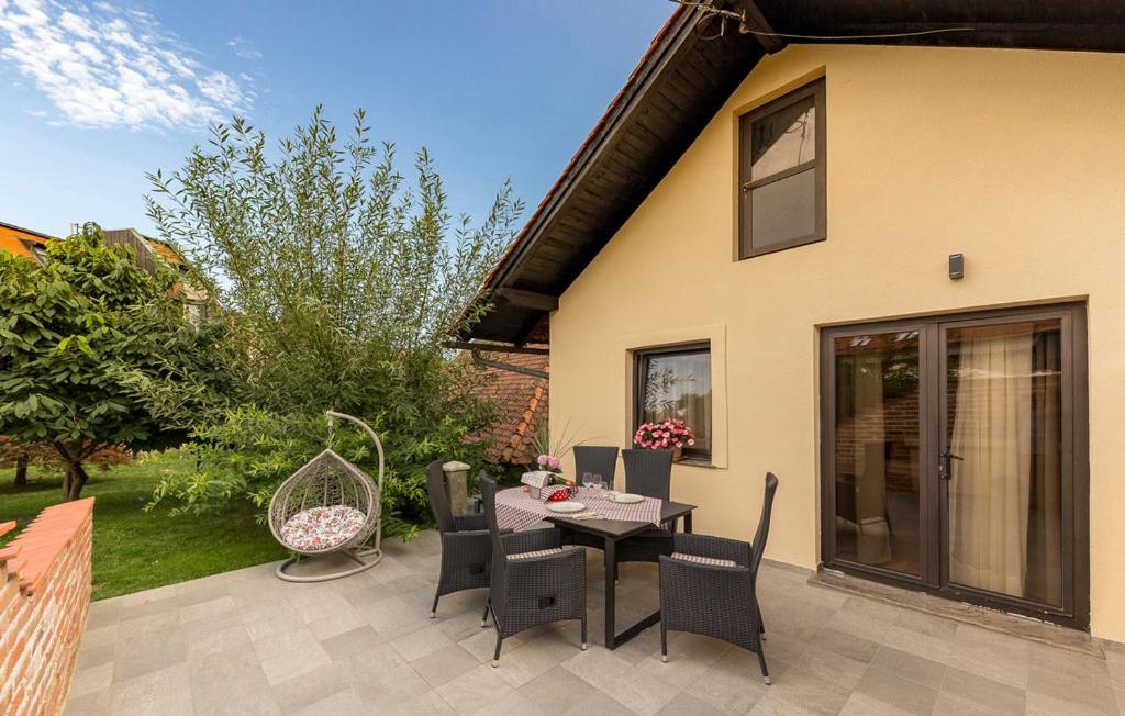a patio with a table and chairs in front of a house at Apartma Rozika in Ptuj