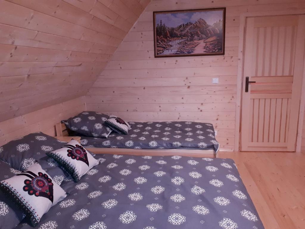 a bedroom with two beds in a attic at Domek w górach pod Jodłami in Nowy Targ