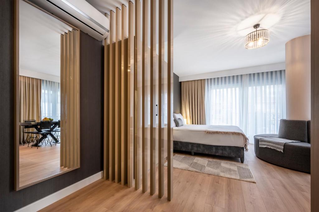 a bedroom with a bed and a couch and a mirror at SVK Bosphorus Residence in Istanbul