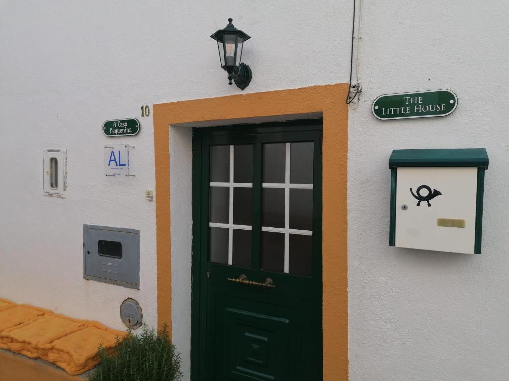 una puerta a un edificio blanco con una puerta verde en A Casa Pequenina - Escusa, Marvão en Marvão