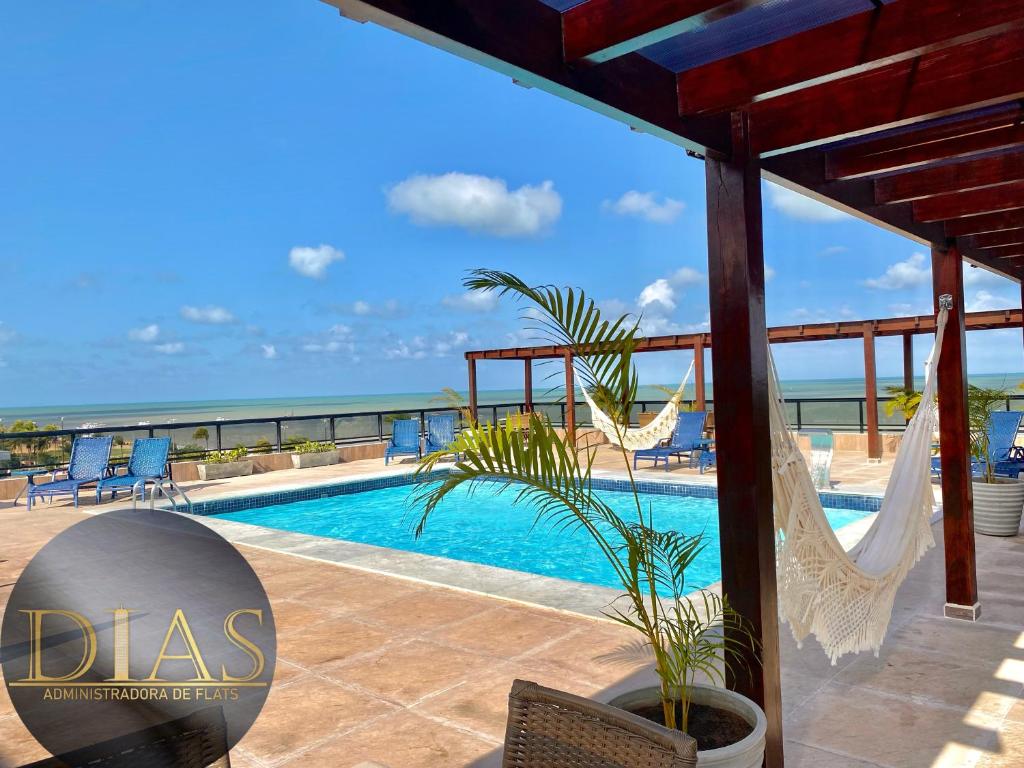 a villa with a swimming pool and a view of the ocean at MARINAS PRAIA Flat in João Pessoa