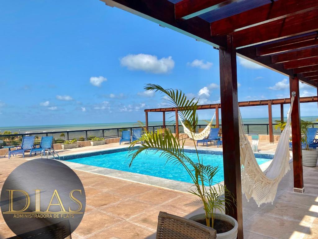 a villa with a swimming pool and a view of the ocean at MARINAS PRAIA Flats in João Pessoa