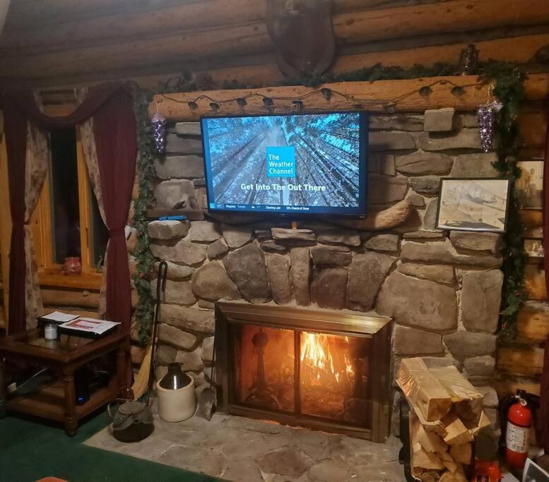 a television sitting on top of a stone fireplace at 1913 LOVE SHACK BETHEL WHITE LAKE NY in White Lake