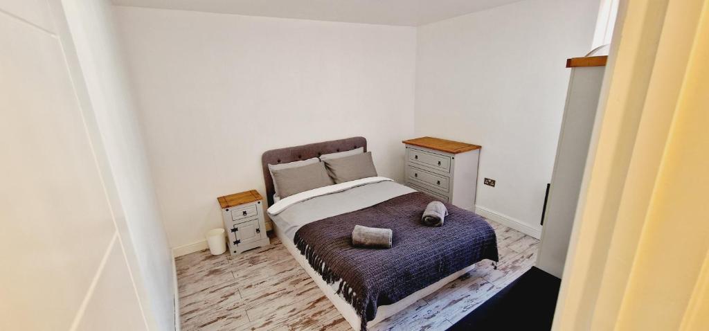 a small bedroom with a bed and a dresser at City centre lovely Apartment with the Cheapest Overnight Parking in Leicester